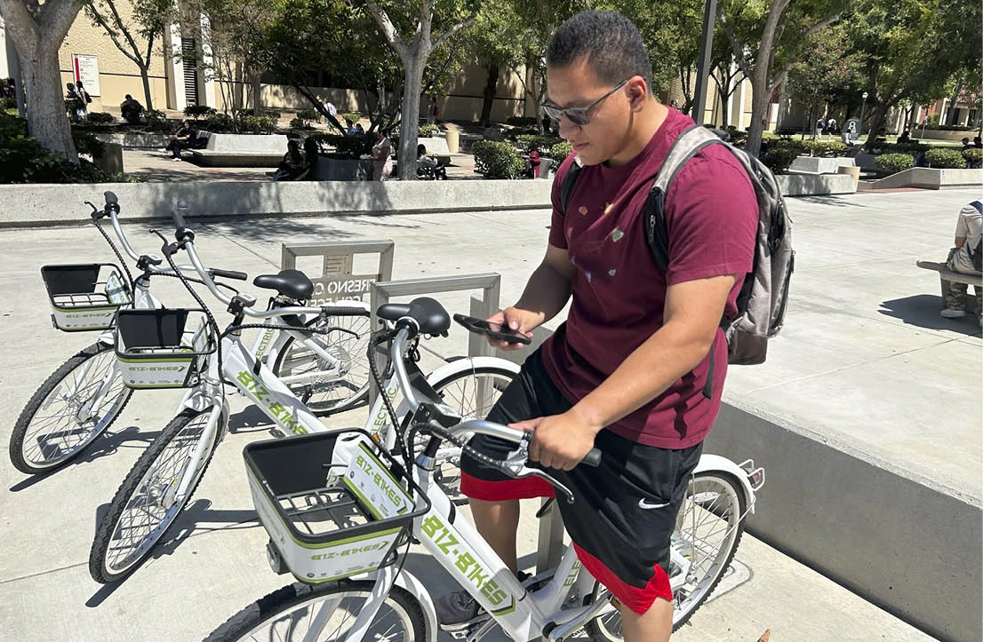 student getting on biz bike