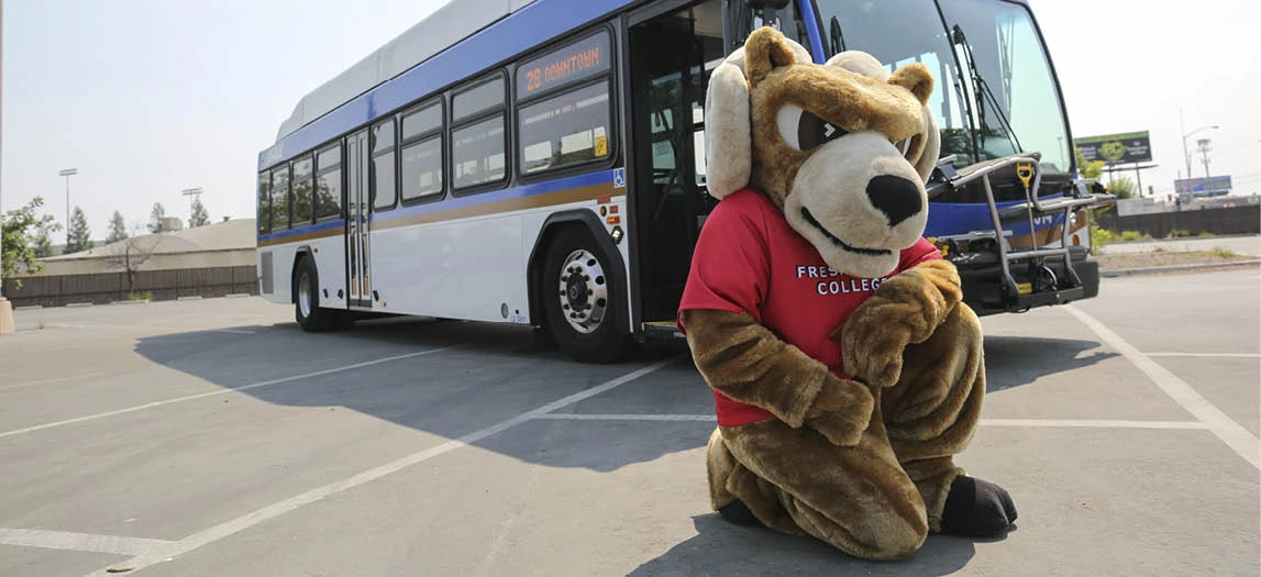 FCC Ram mascot in front of the bus