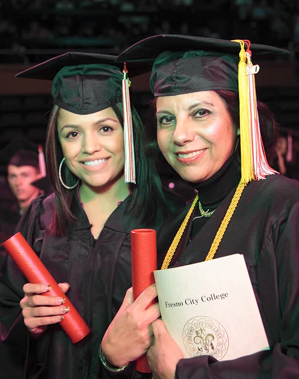 two hispanic women graduates