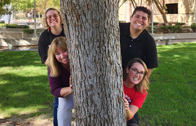 ASL faculty behind tree