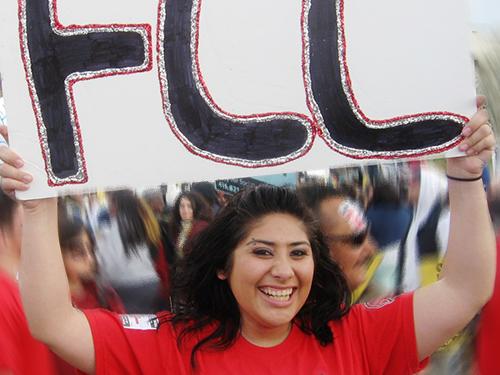 Student holding sign that says FCC