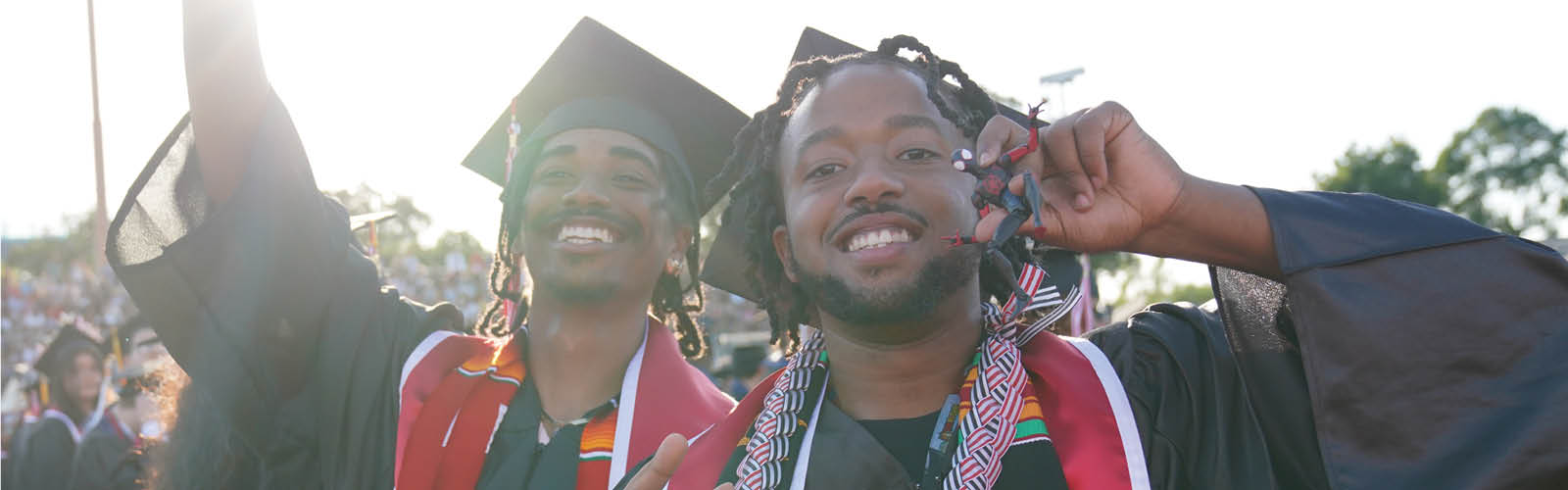 Two students smiling at graduation